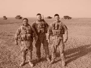sepia-toned archival photo of U.S. Army Veteran Matthew Turner with colleagues in fatigues