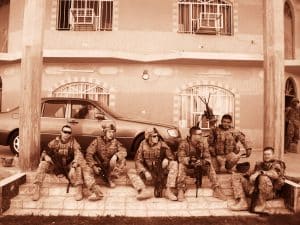 sepia-toned archival photo of U.S. Army Veteran Matthew Turner with colleagues in fatigues