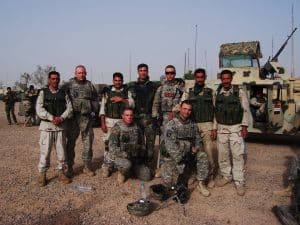 archival photo of U.S. Army Veteran Matthew Turner with colleagues in fatigues