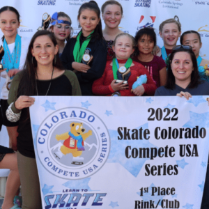A group of skaters from the Greeley Ice Haus and Mountain View Skating Club hold up a banner and medals celebrating a competition victory