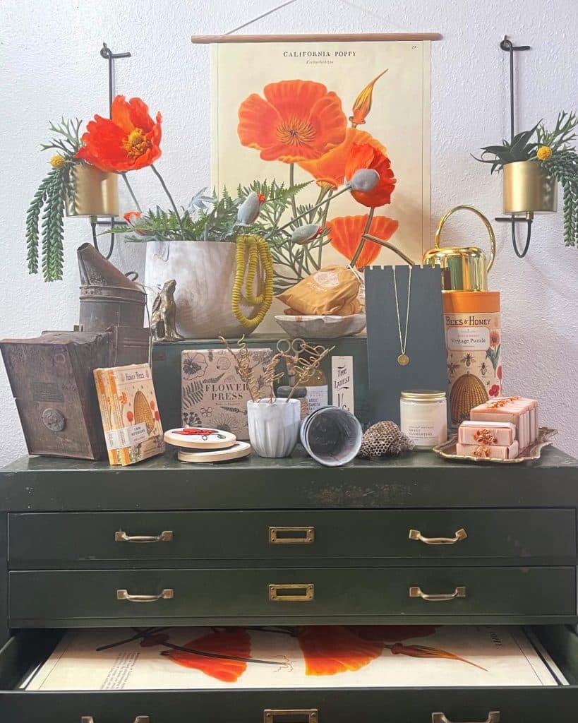 Brooklyn Finds product photo with a vintage green dresser, bright orange poppy artwork and more